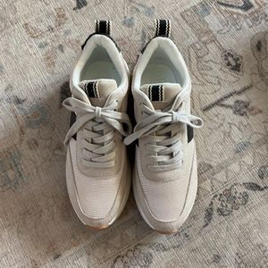 Cream and black sneakers with gold details